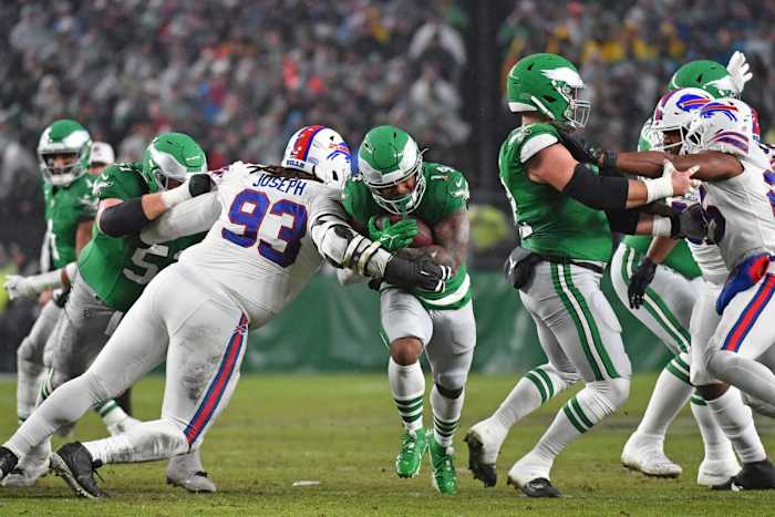 Nov 26, 2023; Philadelphia, Pennsylvania, USA; Philadelphia Eagles running back Kenneth Gainwell (14) runs past Buffalo Bills defensive tackle Linval Joseph (93) during the first quarter at Lincoln Financial Field.